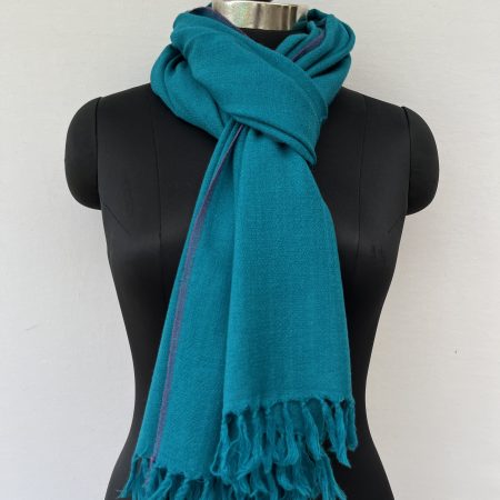Hand-woven merino wool stole in cerulean blue with a thin purple selvedge.