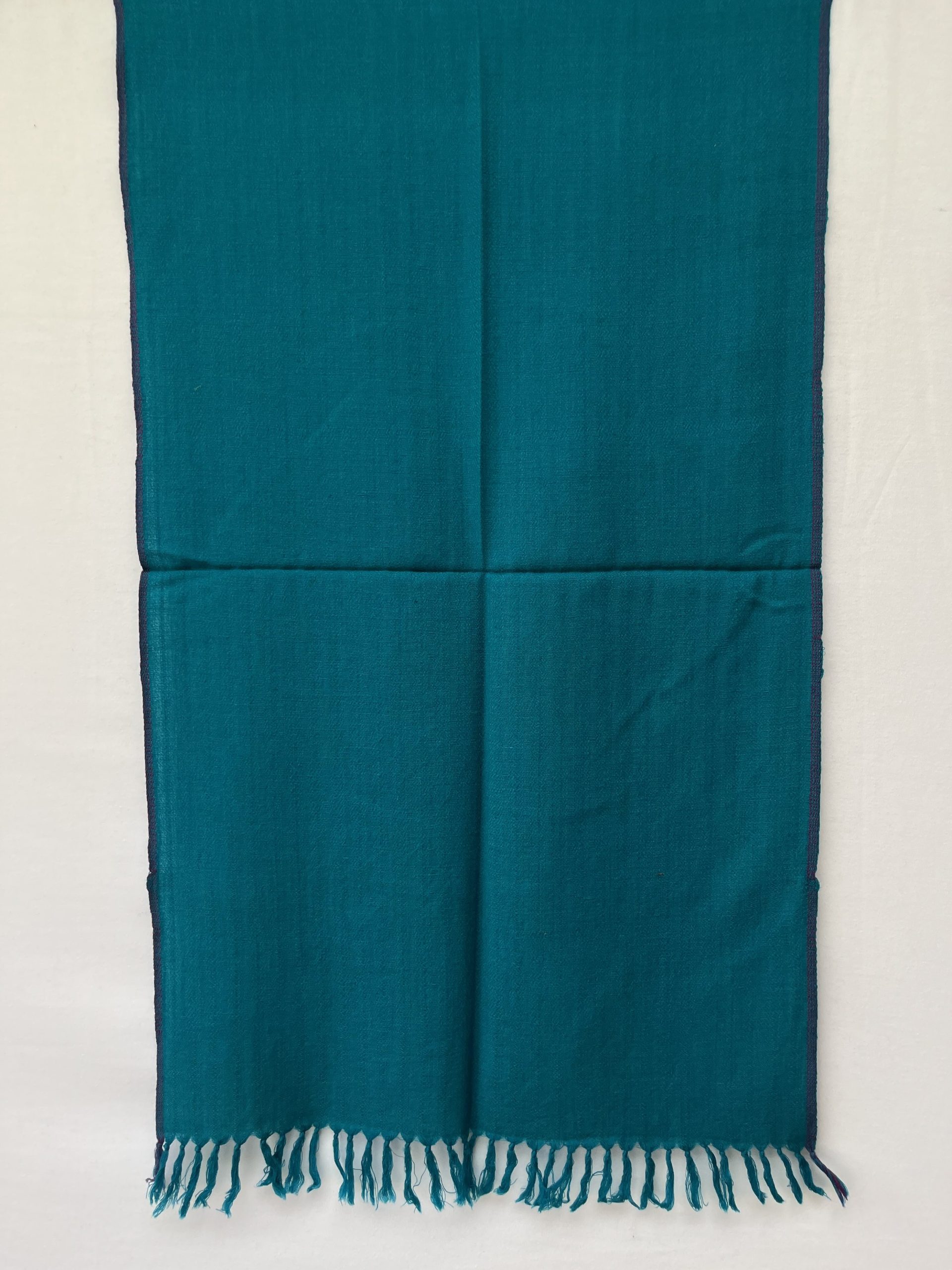 Hand-woven merino wool stole in cerulean blue with a thin purple selvedge.