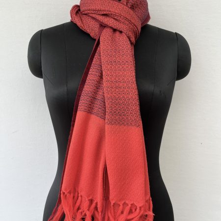 Tomato red hand-woven stole with a navy blue selvedge and navy blue weft.