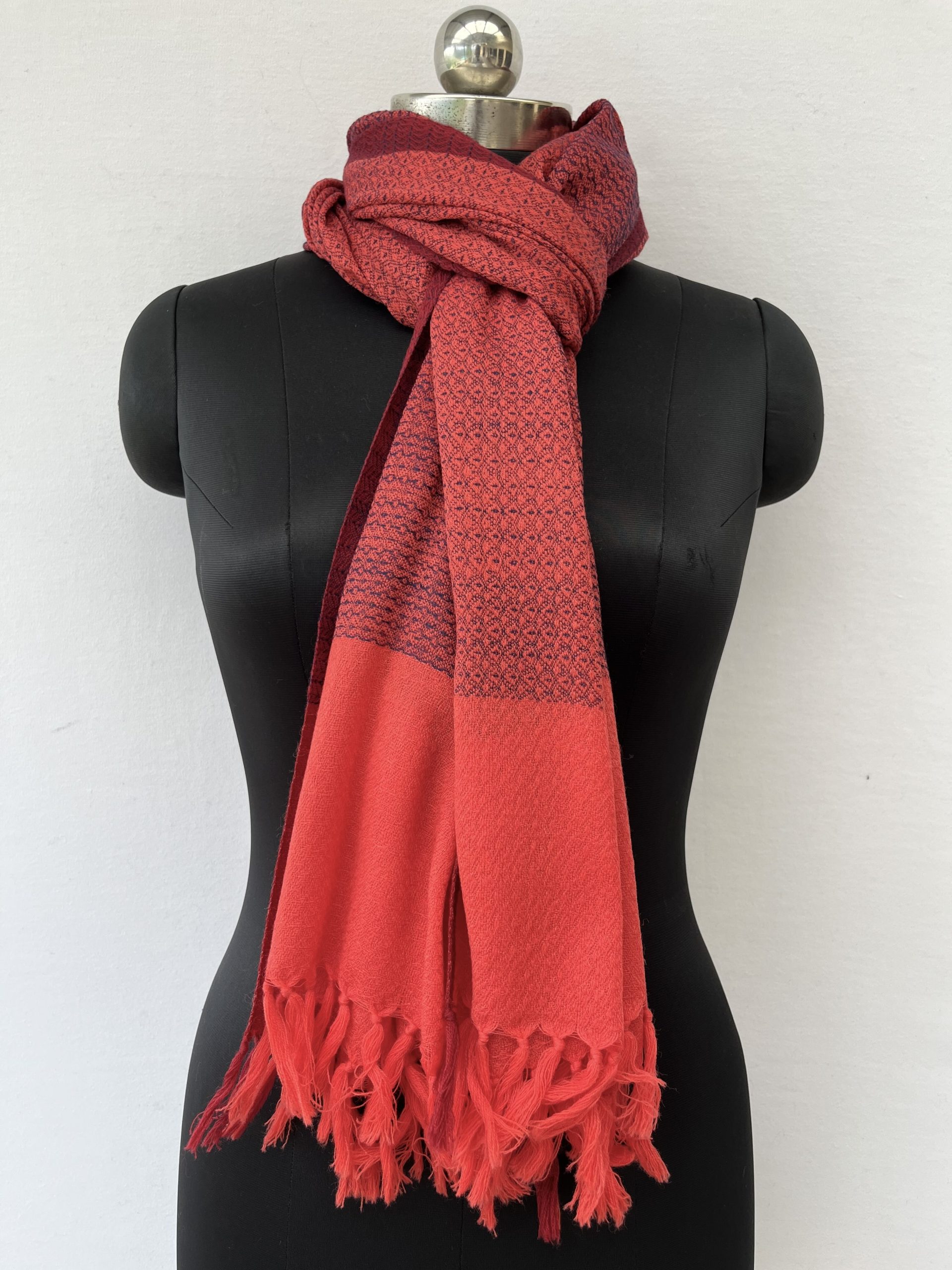 Tomato red hand-woven stole with a navy blue selvedge and navy blue weft.
