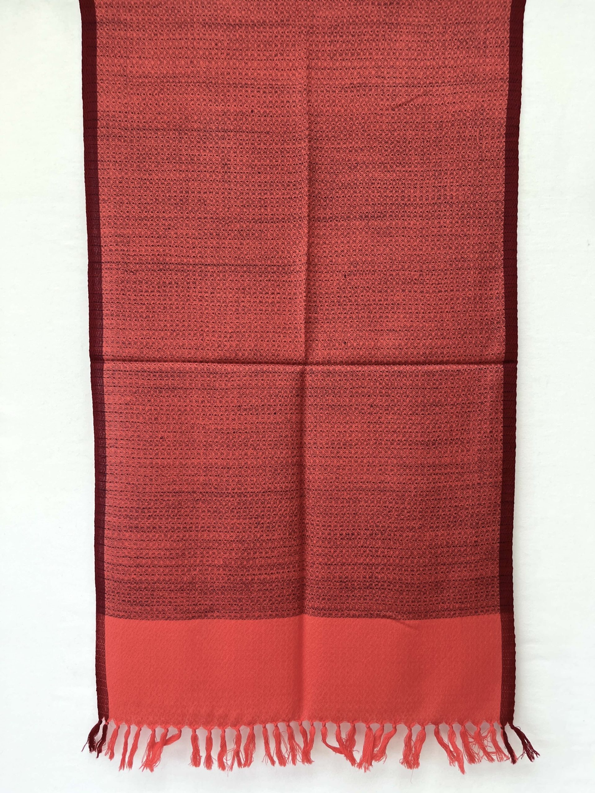 Tomato red hand-woven stole with a navy blue selvedge and navy blue weft.