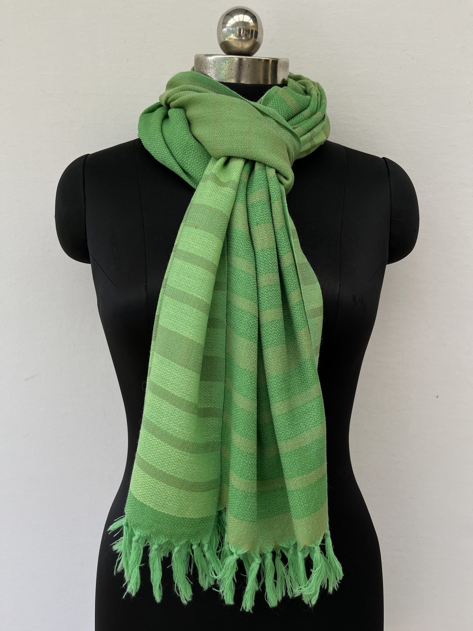 Hand woven merino wool stole with vertical stripes in shades of lime and pear green.