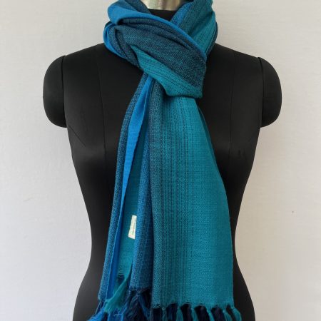 Merino wool hand-woven stole in ombre in shades of blue.