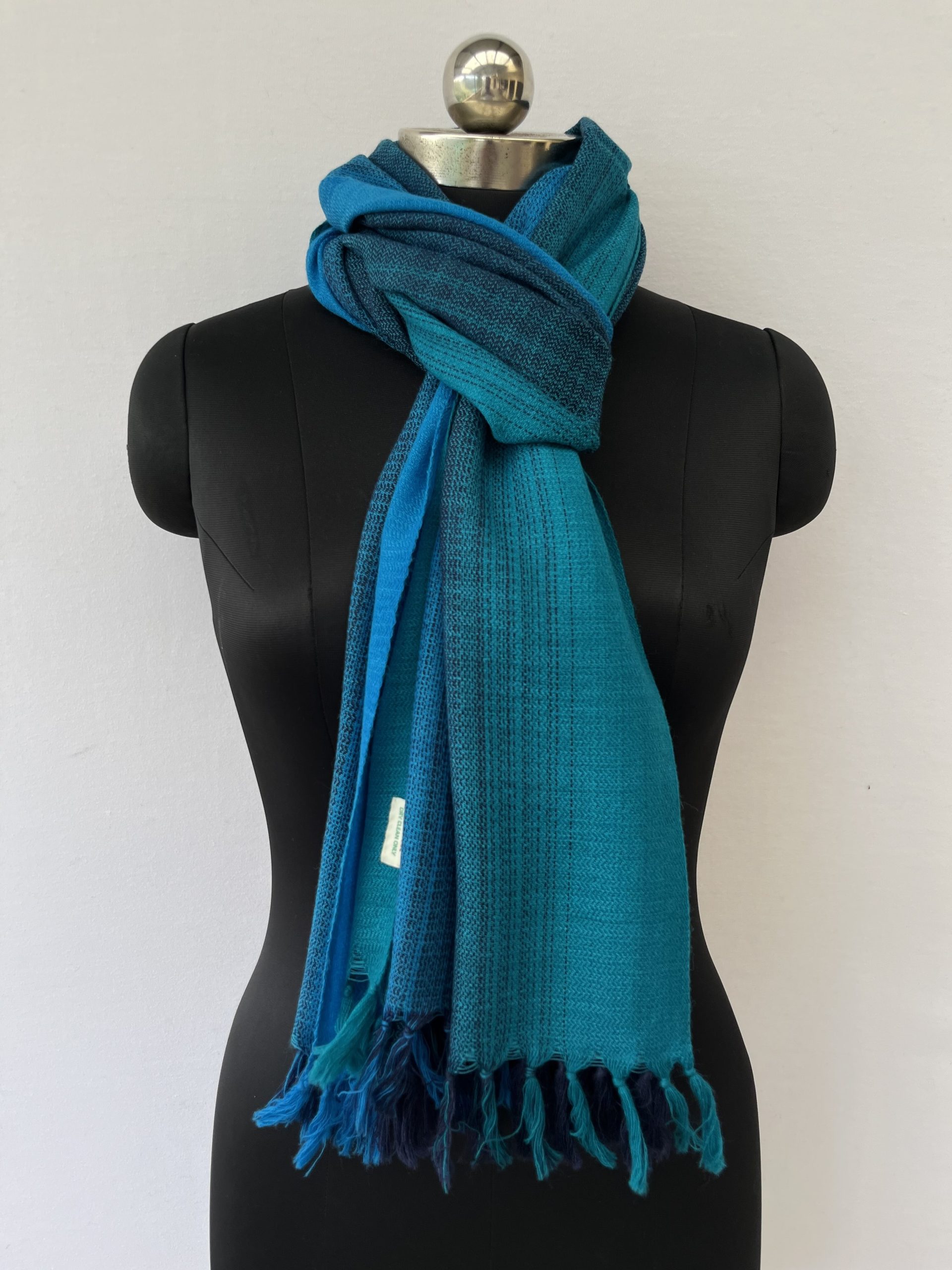 Merino wool hand-woven stole in ombre in shades of blue.