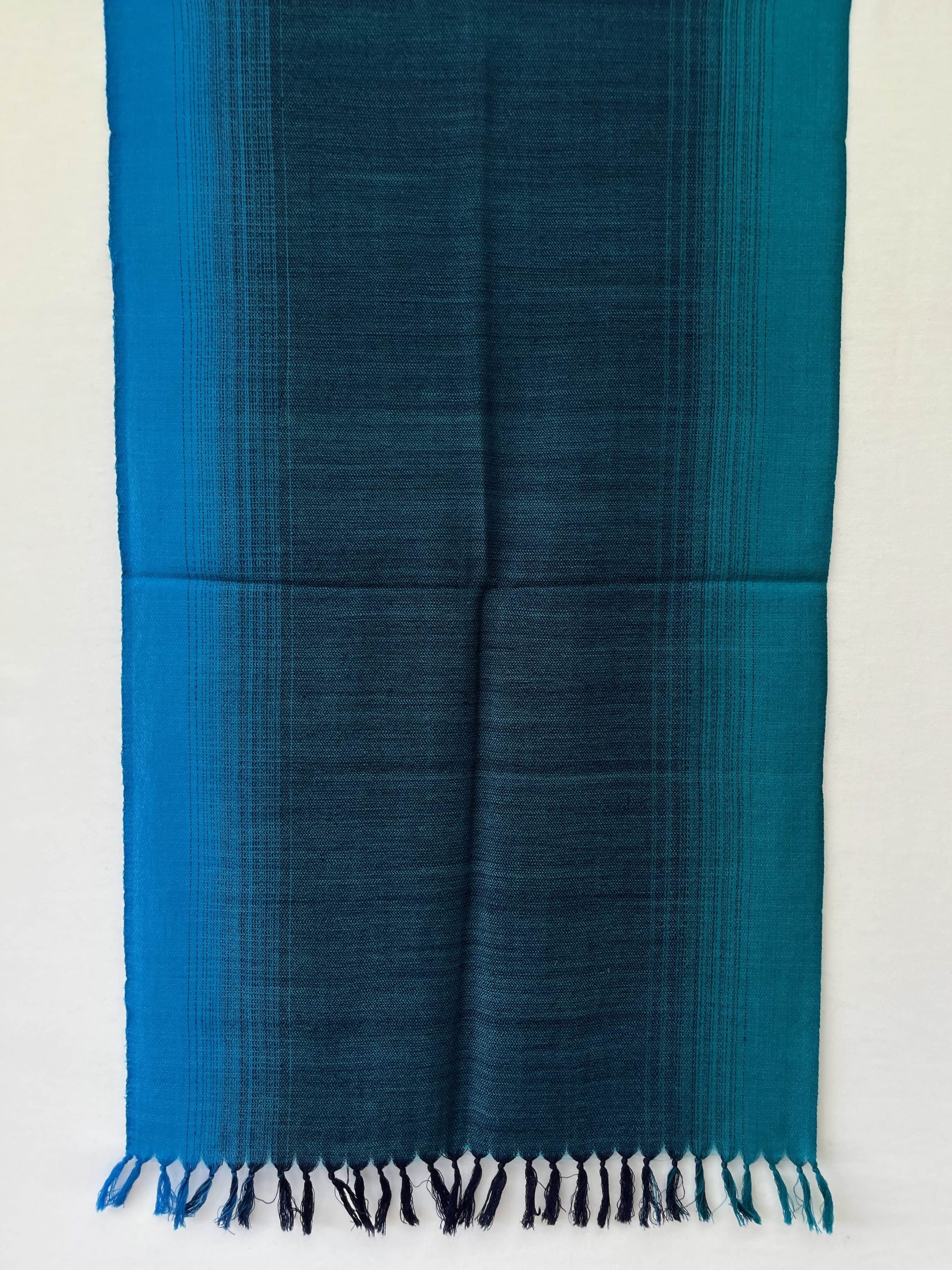 Merino wool hand-woven stole in ombre in shades of blue.