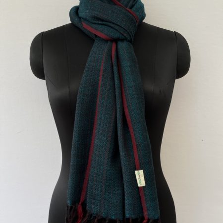 Hand-woven merino wool stole in peacock blue with red selvedge, and red stripes interwoven throughtout the stole.